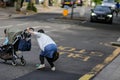 LONDON, UK Ã¢â¬â May 14, 2018: Woman with child in dangerous situation in crossing busy street